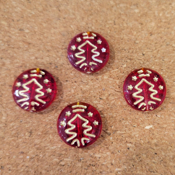 Four transparent ruby red Czech glass disc beads with metallic gold Christmas tree designs.
