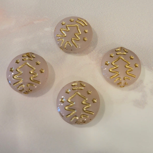 Four milky pink Czech glass disc beads with metallic gold Christmas tree designs.
