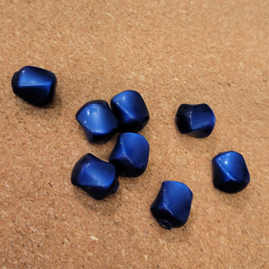 Eight deep blue vintage Lucite beads with rounded angular sides and bright blue highlights.