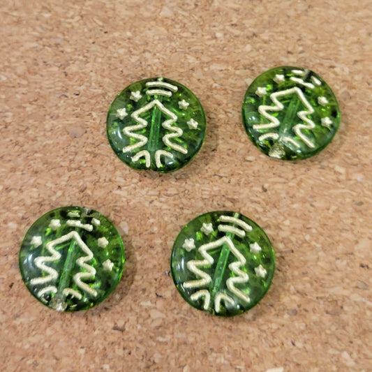 Four transparent green Czech glass disc beads with metallic gold Christmas tree designs.