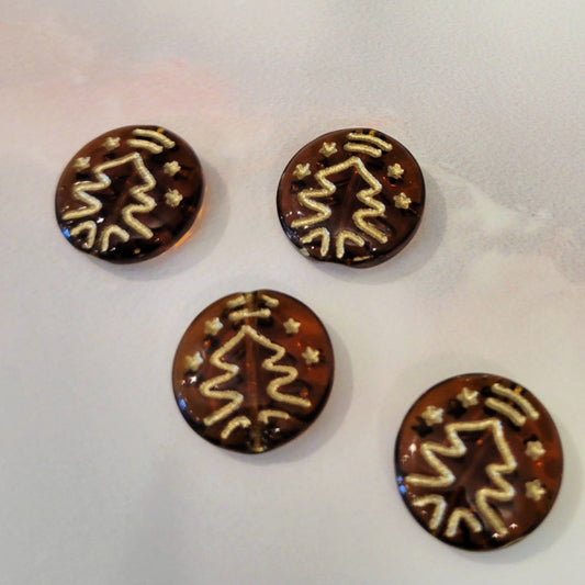 Four transparent brown Czech glass disc beads with metallic gold Christmas tree designs.