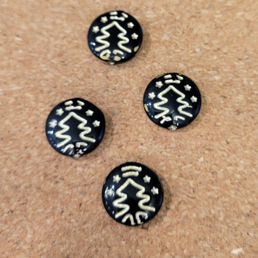 Four opaque black Czech glass disc beads with metallic gold Christmas tree designs.