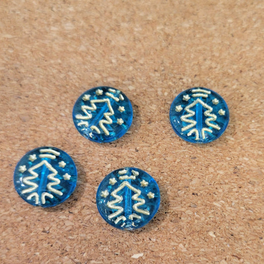 Four transparent aqua blue Czech glass disc beads with metallic gold Christmas tree designs.