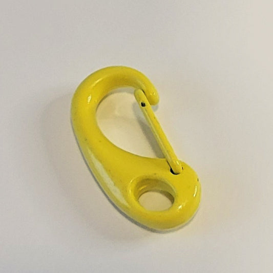 A bright yellow metal carabiner clip photographed on a plain light background.