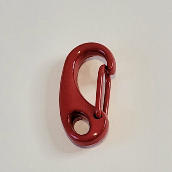A glossy red metal carabiner hook photographed on a plain off-white background.