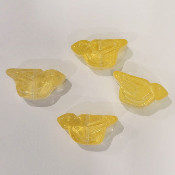 Four transparent yellow pressed glass bird beads