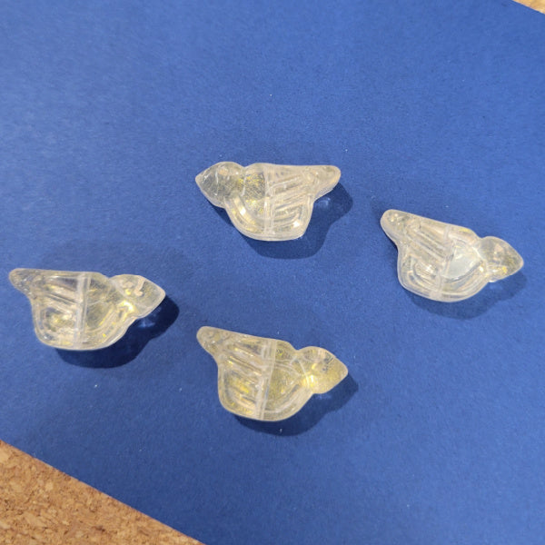 Four crystal clear pressed glass bird beads with a light gold wash