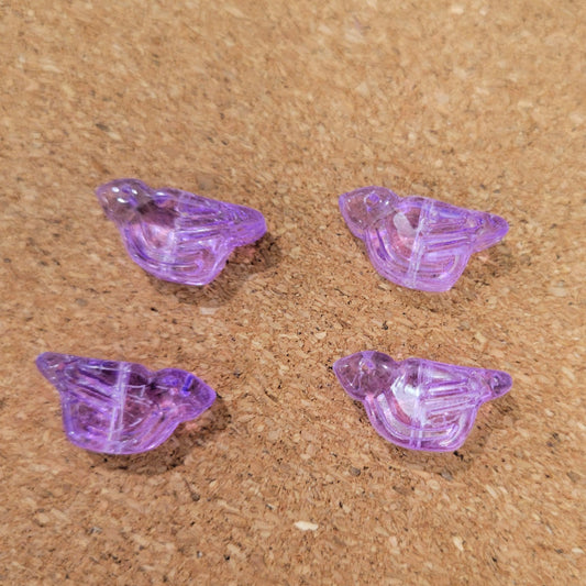 Four transparent purple pressed glass bird beads